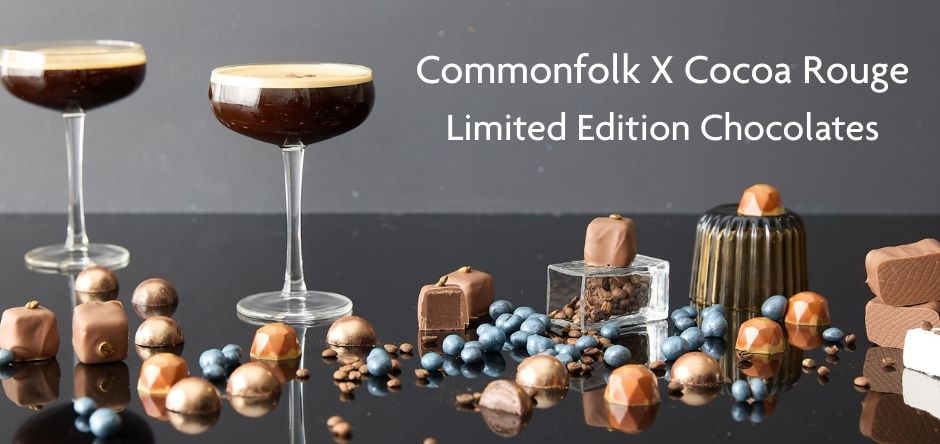 Chocolate products and espresso martinin cocktails with 'Commonfolk X Cocoa Rouge' branding on a dark surface.