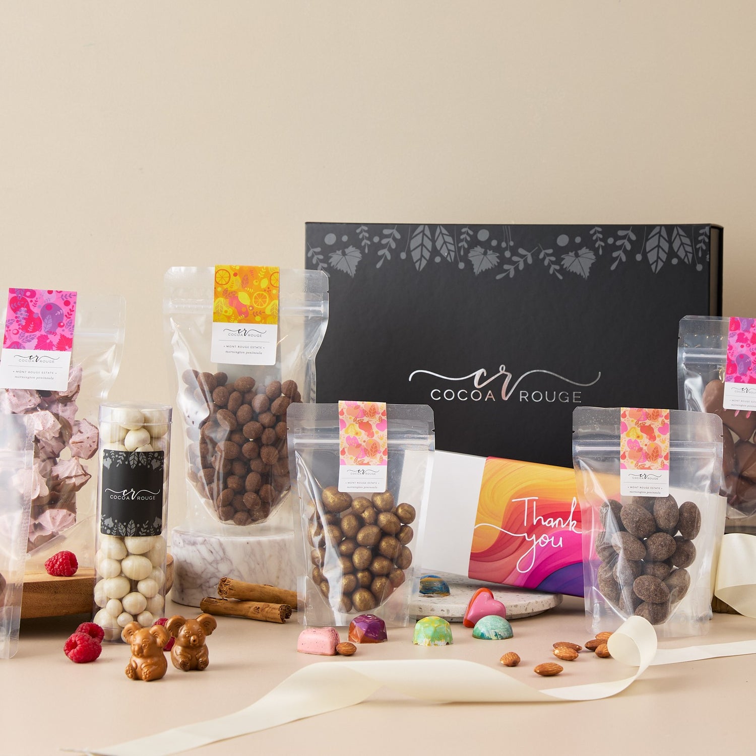 Assorted chocolates perfect for sharing with 'Cocoa Rouge' branding on a beige background