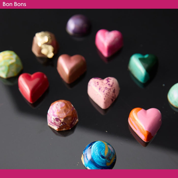 Colorful chocolate bon bons on a dark surface