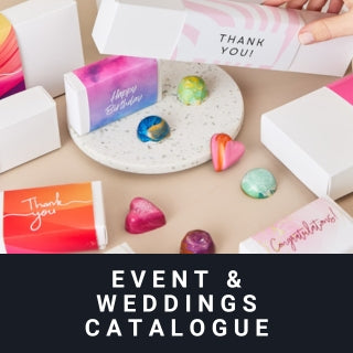 Event and weddings catalogue with gift boxes and decorative items on a table.