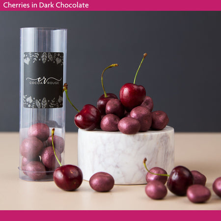 Freeze dried cherries in dark chocolate on a marble plinth