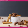 Cinnamon sultanas in a marble bowl with cinnamon sticks on a dark background