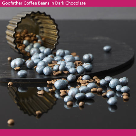 Godfather Coffee Beans in Dark Chocolate on a dark surface.