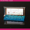 Chocolate bar with 'Congratulations' text and personalized label on a dark background
