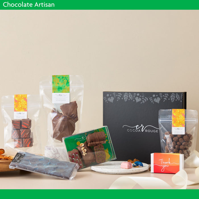 Chocolate products including wrapped chocolates and a box with 'Cocoa Rouge' branding on a neutral background.  Chocolate Artisan