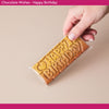Chocolate bar with 'Happy Birthday' text held by a hand on a beige background