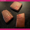 Three dark chocolate-covered honeycomb pieces made with manuka and tea tree honey