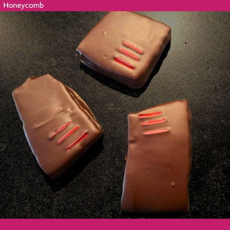Three dark chocolate-covered honeycomb pieces made with manuka and tea tree honey