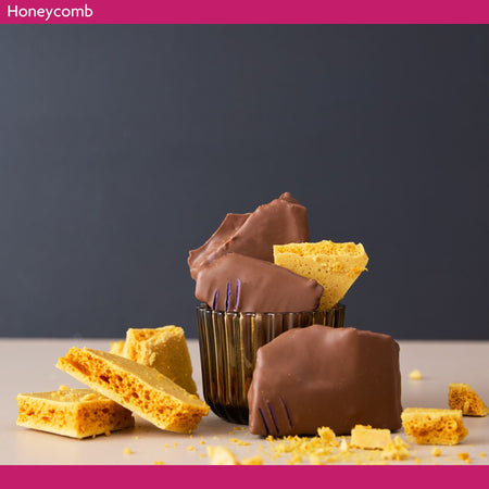 Chocolate-dipped honeycomb pieces on a dark background