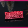 Red 'Merry Christmas' chocolate bar on a dark background