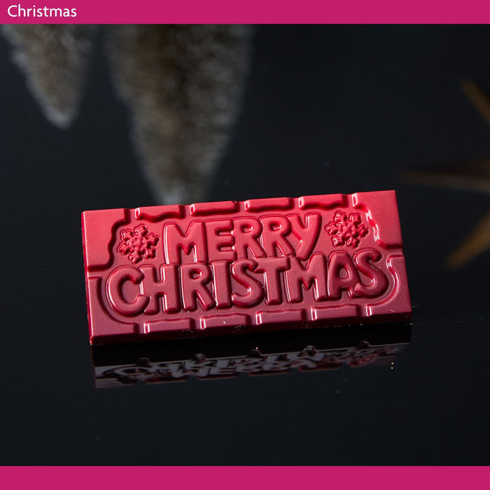 Red 'Merry Christmas' chocolate bar on a dark background