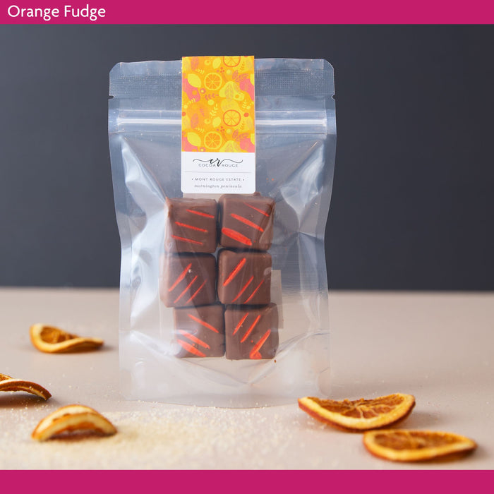 Packaged orange fudge with decorative label on a neutral background