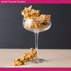 Salted Caramel Clusters in a glass on a neutral background