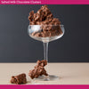 Salted Milk Chocolate Clusters in a glass with a dark background