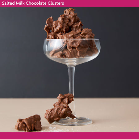 Salted Milk Chocolate Clusters in a glass with a dark background