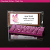 Chocolate bar with a business card featuring a butterfly design on a black background