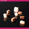 Turkish Delight pieces on a black background coated in milk chocolate